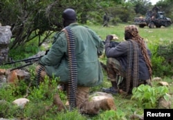 FILE - Soldiers from Somalia's Puntland keep guard on high grounds at the Galgala hills, during preparations for an offense against al-Shabaab militants, north of the capital Mogadishu, Jan. 9, 2015.