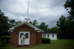 Eddie Keith, 65, of Dawson, Ga., locks the church doors as he leaves on April 19, 2020, in Dawson, Ga. He visits his pastor's church a couple times a week.