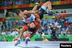 Migran Arutyunyan of Armenia and Adham Ahmed Saleh Ibrahim Kahk of Egypt compete in Greco-Roman wrestling.