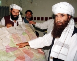 FILE - Jalaluddin Haqqani, right, founder of the Haqqani network, is seen during a visit to Islamabad, Pakistan, Oct. 19, 2001. A speech by one of his sons, Sirajuddin Haqqani, who now heads the network, is drawing renewed attention.