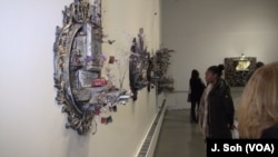 Viewers study Hafez's work. One finds the beauty in chaos.