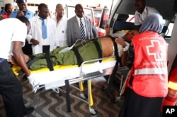Medics help an injured person at Kenyatta National Hospital in Nairobi, Kenya, April 2, 2015, after an attack by gunmen at Garissa University College in northeastern Kenya.