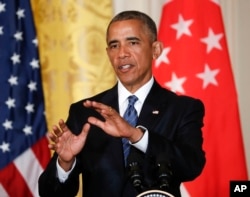 President Barack Obama answers questions during a joint news conference with Singapore's Prime Minister Lee Hsien Loong in the East Room of the White House in Washington, Aug. 2, 2016.