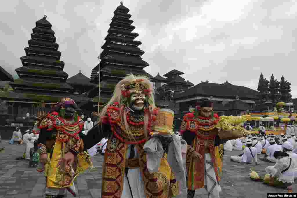 Artists perform Sidakarya mask dancing during mass prayers, expressing gratitude for the handling of the new coronavirus and seeking blessings for the start of a "new normal", at Besakih temple in Karangasem, Bali, Indonesia.