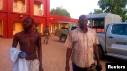 Injured policemen are seen outside Shehu's Palace of Bama, Borno State, Nigeria. May 7, 2013.