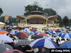 Kenyans gather under umbrellas during a Mass by Pope Francis at the University of Nairobi, in Kenya, Nov. 26, 2015. The pope is making his first trip to Africa.