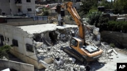 Israeli authorities demolish a Palestinian owned house in east Jerusalem, Aug. 21, 2019.