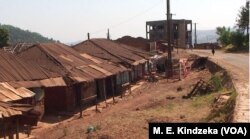 FILE - Clothes hang on a clothes line in front of a row of largely abandoned homes, in Kumbo, Cameroon, Jan. 3, 2019.