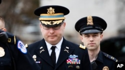Army Lieutenant Colonel Alexander Vindman, a military officer at the National Security Council, center, arrives on Capitol Hill in Washington, to testify as part of the U.S. House of Representatives impeachment inquiry into President Donald Trump.