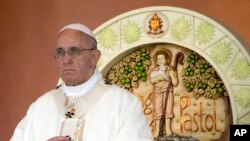 FILE - Pope Francis prays during a Mass at Rizal Park in Manila, Philippines, Jan. 18, 2015. 