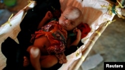 A ten-day-old infant sleeps inside a temporary shelter at Kutupalong refugee camp near Cox's Bazar, Bangladesh, Nov. 8, 2017. 