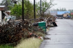FILE - Debris sits near a street after Hurricane Laura hit nearly a month ago ahead of Hurricane Delta, in Lake Charles, Louisiana, Oct. 9, 2020.
