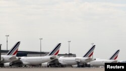 FILE - Air France planes are parked on the tarmac at the Paris Charles de Gaulle airport in Roissy, France, June 19, 2019. 