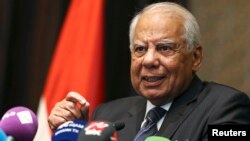FILE - Egypt's Prime Minister Hazem el-Beblawi gestures during a news conference in Abu Dhabi, Oct. 27, 2013. 