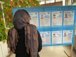 A voter reads election candidates posters during parliamentary election in Tashkent, Uzbekistan December 22, 2019