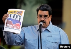 FILE - Venezuela's President Nicolas Maduro attends a gathering in support of his government in Caracas, Venezuela, Feb. 7, 2019.