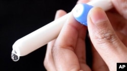 A drop of microbicide gel is photographed as it is squeezed from an applicator at the Baragwanath Hospital in Soweto, South Africa. The hospital took part in a large microbicide study called CAPRISA 004.