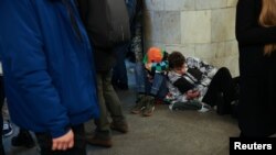 People take shelter inside the metro station amid Russian missile attacks in Kyiv, Ukraine