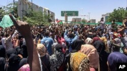 Protesters rally in front of the military headquarters in the capital Khartoum, Sudan, Monday, April 8, 2019.