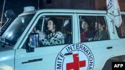 This image taken from video shows an International Red Cross vehicle reportedly carrying hostages released by Hamas as it crosses the Rafah border point in the Gaza Strip towards Egypt, from where they would be flown to Israel, on Nov. 24, 2023.