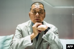 FILE - In this picture taken on June 16, 2020, media tycoon Jimmy Lai poses during an interview with AFP at the Next Digital offices in Hong Kong.