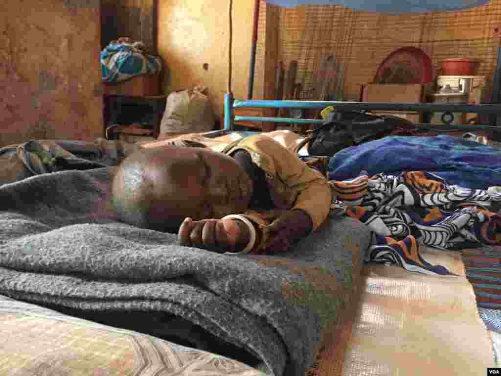 A young IDP sleeps inside a church building at the St. Mary Help of Christians Cathedral in Wau, Western Bahr el Ghazal, where his family is staying, Dec. 8, 2016. (VOA/Jill Craig)