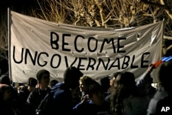 Protestors against a scheduled speaking appearance by polarizing Breitbart News editor Milo Yiannopoulos march on the University of California at Berkeley campus, Feb. 1, 2017, in Berkeley, Calif.