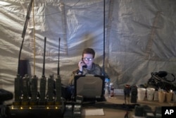 A U.S. Air Force service member uses radio communication at the command and control center inside a coalition air base in Qayyarah, some 50 kilometers south of Mosul, Iraq, Oct. 28, 2016. The U.S. military says Iraqi forces have retaken 40 villages from the Islamic State group near Mosul since a massive operation to drive the militants from the city began last week.