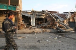FILE - Afghan security personnel arrive at the site of suicide attack in Jalalabad east of Kabul, Afghanistan, Oct. 25, 2019. The Taliban claimed responsibility for the attack.