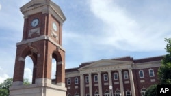 FILE - The Autherine Lucy Clock Tower at the Malone Hood Plaza stands in front of Foster Auditorium on the University of Alabama campus in Tuscaloosa, Ala., June 16, 2019. 