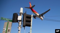 FILE - A passenger jet makes its final approach for landing into Sydney Airport, Apr. 26, 2021.