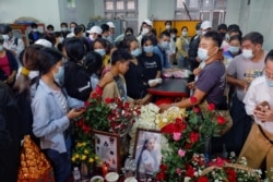 People attend the funeral of Angel, 19-year-old protester also known as Kyal Sin who was shot in the head as Mynamar forces opened fire to disperse an an anti-coup demonstration in Mandalay, Myanmar, March 4, 2021.