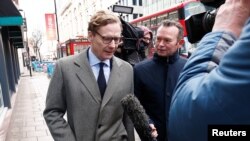 FILE - Alexander Nix, CEO of Cambridge Analytica, arrives at the offices of Cambridge Analytica in London, March 20, 2018.