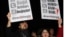 FILE - People shout slogans as they hold placards that read "stop censorship" during a rally in Ankara, Turkey, Jan. 18, 2014.