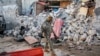FILE - A soldier walks past wreckage in the aftermath of an attack on the Afrik Hotel in Mogadishu, Somalia, on Feb. 1, 2021. At least five people died in the attack by al-Shabab militants.