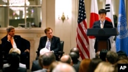 Secretary of State John Kerry, left, and State Department special envoy Robert King, center, listen as North Korean human rights activist Shin Dong-hyuk delivers remarks during an event on human rights in North Korea at the Waldorf Astoria Hotel Tuesday, 