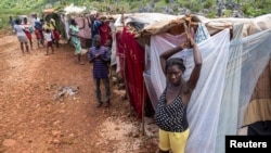 People stay in makeshift tents at a camp after the 7.2 magnitude quake on August 14 damaged or destroyed their houses in the Nan Konsey neighborhood in Pestel, Haiti August 23, 2021. REUTERS/Ricardo Arduengo