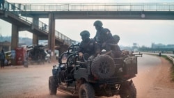 FILE - In this Jan. 14, 2021, file photo, security forces patrol the streets on election day in Kampala, Uganda.