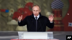 FILE - Russian President Vladimir Putin addresses Russian volunteers in Moscow, June 1, 2016.