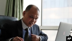 FILE - Chinese lawyer Yu Wensheng is seen working at his office in Beijing, Feb. 24, 2107.