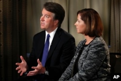 FILE - Brett Kavanaugh, with his wife Ashley Estes Kavanaugh, answers questions during a FOX News interview in Washington, Sept. 24, 2018, about allegations of sexual misconduct against the Supreme Court nominee.