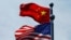 FILE - A Chinese and U.S. flag flutter near The Bund, before U.S. trade representatives meet with their Chinese counterparts for talks in Shanghai, China, July 30, 2019.