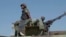FILE - In this image made from video, a Mozambican soldier rides on an armored vehicle at the airport in Mocimboa da Praia, Cabo Delgado province, Mozambique, Aug. 9, 2021. The U.N. Office for the Coordination of Humanitarian Affairs is seeking $413 million to support the region.