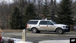 FILE - A Royal Canadian Mounted Police cruiser sits in Quebec, Canada, across the border from the US, March 18, 2020, at Derby Line, Vt.