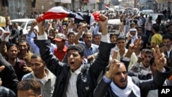 Yemeni anti-government demonstrators chant slogans during a demonstration celebrating the resignation of Egyptian leader Hosni Mubarak and demanding the ouster of their own president, in Sanaa, Yemen, Feb 12, 2011