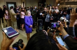 FILE - U.S. Representative Liz Cheney speaks to the media as she arrives on Capitol Hill in Washington after Republicans ousted her from a leadership post over her criticism of former President Donald Trump's false claims of a stolen election.