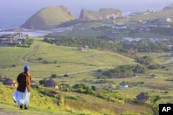 A woman walks to a clinic in Oliver Tambo District in South Africa. Millions of people in the country struggle to access healthcare