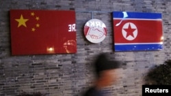 FILE - Flags of China and North Korea are seen outside the closed Ryugyong Korean Restaurant in Ningbo, Zhejiang province, China, April 12, 2016.