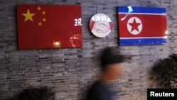 FILE: Flags of China and North Korea are seen outside the closed Ryugyong Korean Restaurant in Ningbo, Zhejiang province, China, April 12, 2016.