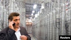 FILE - An official from Iran's Atomic Energy Organization stands in front of uranium enriching centrifuges at Shahid Beheshti University in Tehran.